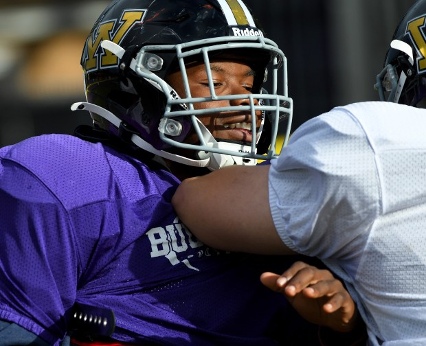 Offensive lineman Lamero Ceasar gets met by a team mate who was playing on the opposing defensive line during practice at Waukegan's football practice at Weiss Field, Tuesday, Oct. 15, 2024. (Rob Dicker /for the News-Sun)