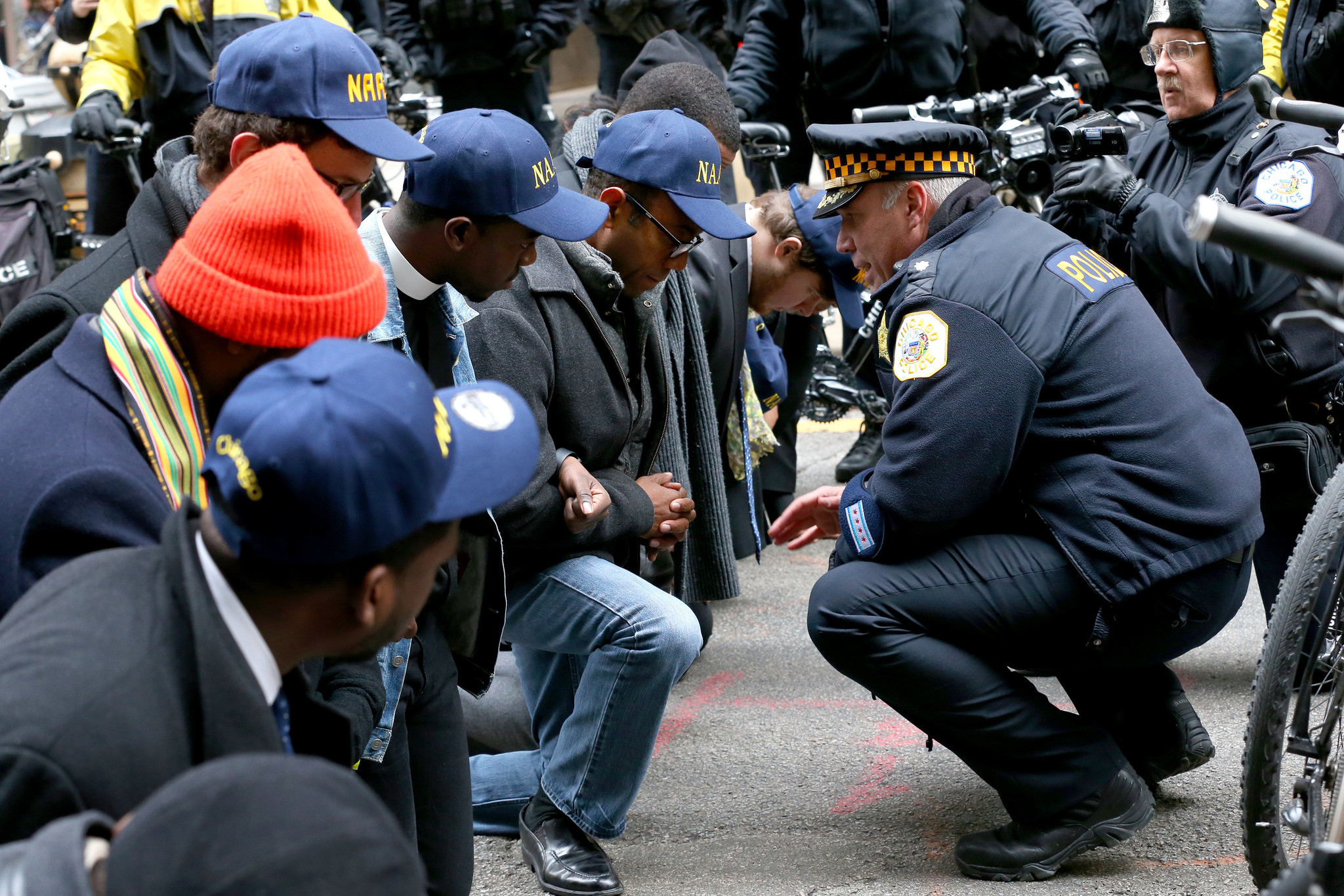 An officer talks Nov. 30, 2015 to NAACP chief Cornell William...