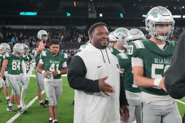 De La Salle High School coach and former NFL running back Maurice Jones-Drew shakes hands after a football game between the NFL Academy team and De La Salle High School in London on Oct. 8, 2024. (AP Photo/Kin Cheung)