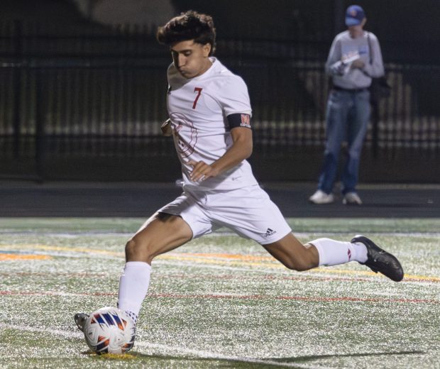 Naperville Central's Aidan DiClemente (7) scores a penalty kick against Plainfield Central during a Class 3A Naperville North Sectional semifinal game in Naperville on Tuesday, Oct. 29, 2024. (Troy Stolt / for the Naperville Sun)