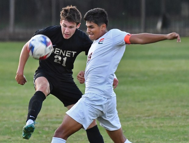 Benet's Brendan Bergnach (21) tangles for the ball with Plainfield East's Tristan Rosas during a game Monday, Sept. 30, 2024 in Lisle...(Jon Cunningham/for The Naperville Sun)