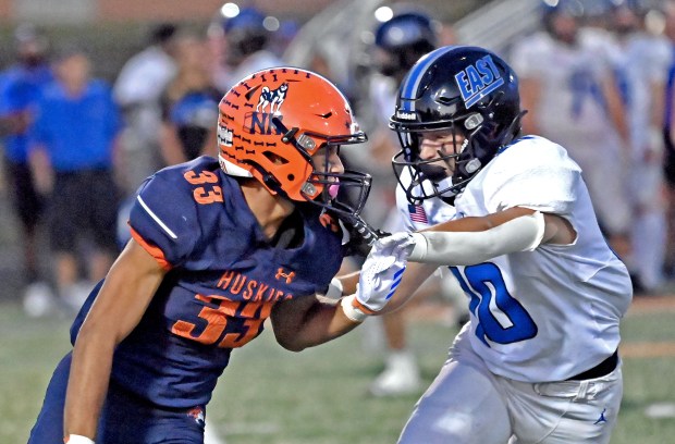 Naperville North's Edward Mumford fights off a block from Lincoln-Way East's MJ Schley. Naperville North lost to Lincoln-Way East in football, 49-17, Friday, Sept. 20, 2024, in Naperville, Illinois. (Jon Langham/for Naperville Sun)