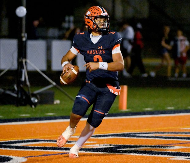 Naperville North quarterback Jacob Bell (2) looks for an open receiver against Neuqua Valley at home in Naperville on Friday, Oct. 11, 2024.  (Mark Black / for the Naperville Sun)