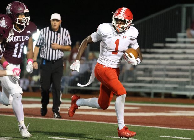 Naperville Central's DeShaun Williams (1) picks up yards during a game at Lockport on Friday, Oct. 4, 2024. (Talia Sprague / Naperville Sun)