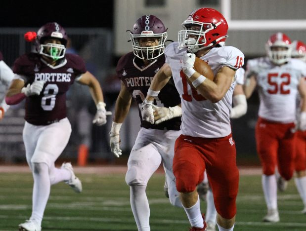 Naperville Central's Gavin Wade (18) runs for a first down during a game at Lockport on Friday, Oct. 4, 2024. (Talia Sprague / Naperville Sun)