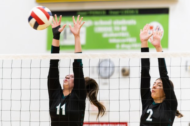 Waubonsie Valley's Liv O'hara (11) blocks a spike against Naperville North during a DuPage Valley Conference match in Aurora on Thursday, Oct. 3, 2024. (Troy Stolt / Naperville Sun)