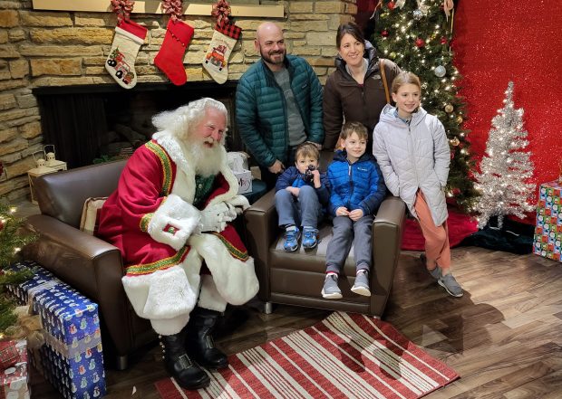 A family poses for a photo at Santa's Workshop, an annual Naperville Park District program that this year will be available from Dec. 2 to 22 at the Paddleboat Quarry Rentals. (Naperville Park District)