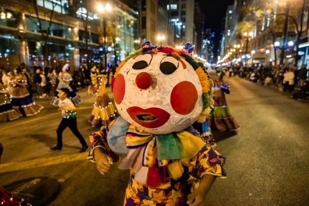 Performers with the Necalli Cultural Movement in the 2022 Arts in the Dark parade on State Street in Chicago. (Distract Your Face photo)