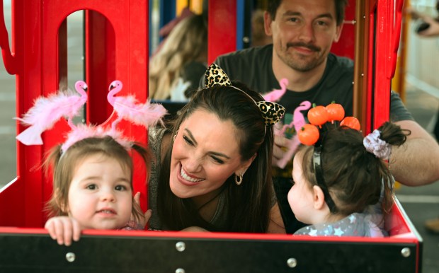 Tyler and Lindsay Dailey of Glenview are on the kiddie train with their children (left) Robby, 1, and Rylan, 3, at the Halloween SKELEbration! event in Glenview at the Park Center on Oct. 18, 2024. (Karie Angell Luc/Pioneer Press)