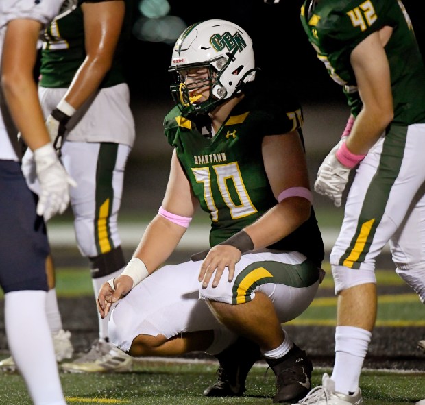 Glenbrook North's Samuel Cray Paich (70) kneels down before getting into a four-point stance while playing defensive nose tackle Glenbrook North's football team hosted Central Suburban Conference South Division rival New Trier and were defeated 48-18 Thursday, Oct. 10, 2024. (Rob Dicker / for Pioneer Press)