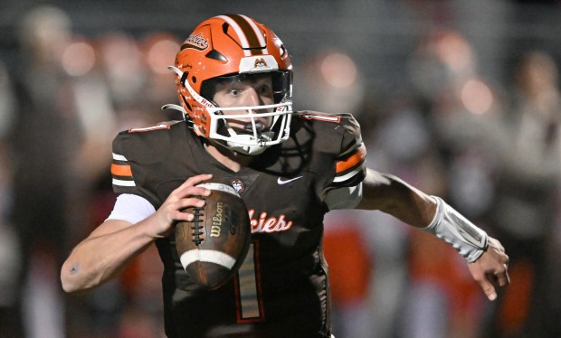 Hersey quarterback, Colton Gumino keeps the ball, and scores during the 3rd quarter of Friday evening's game against Rolling Meadows, Oct. 18, 2024. Hersey won the game, 49-7. (Brian O'Mahoney for the Pioneer Press)