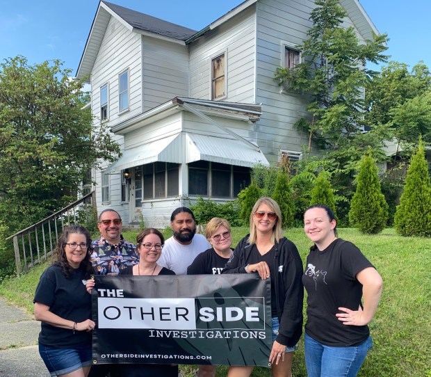 Members of Other Side Investigations gather outside the mysterious Monroe House in Hartford City, Indiana. (Christine Lopez Randall)