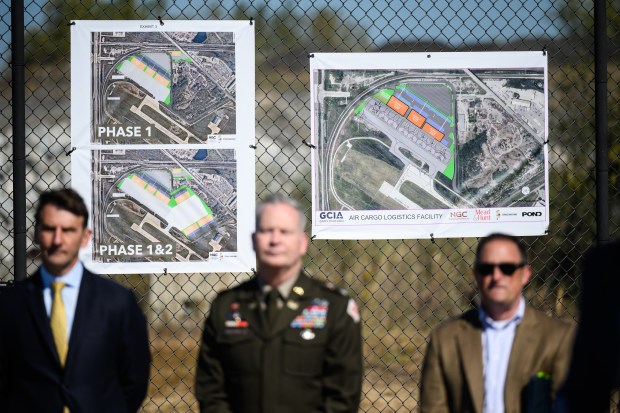 Renderings of an approximately $24 million infrastructure enhancement plan at the Gary/Chicago International Airport are on display behind officials before a groundbreaking ceremony for the project on Tuesday, Oct. 8, 2024. (Kyle Telechan/for the Post-Tribune)