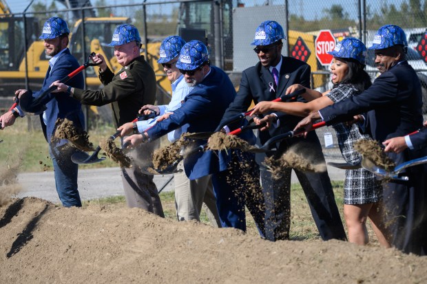 Officials throw shovelfuls of dirt during a ceremonial groundbreaking ceremony to mark the start of construction on an approximately $24 million infrastructure enhancement plan at the Gary/Chicago International Airport on Tuesday, Oct. 8, 2024. (Kyle Telechan/for the Post-Tribune)