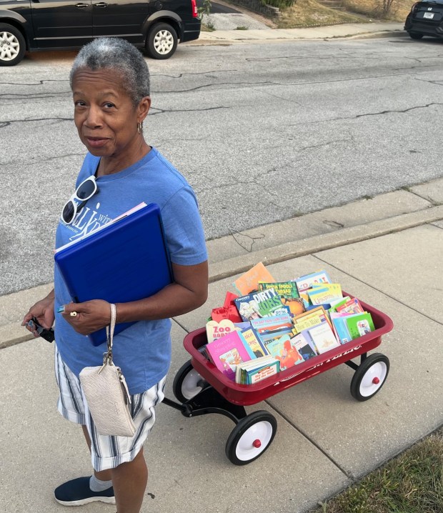 BBB4E volunteer Eunice Jarrett worked with the Book Brigade teams as they recently delivered free books to neighborhood children. The Brigade takes place three times a year, targeting various areas in Hammond. (Sue Ellen Ross/Post-Tribune)