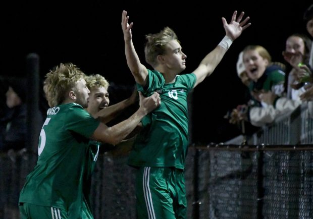 Forward William Donley celebrates with teammates and fans after scoring the only goal early in the second half of the Vikings IHSAA regional semifinal game against Munster at Valparaiso High School Thursday Oct. 17, 2024. (Andy Lavalley/for the Post-Tribune)