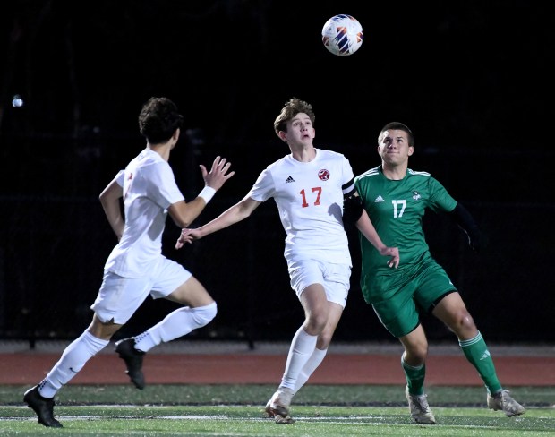 Munster's Jacob Linn battles for control of the ball with the Vikings' Devon Hinko during their IHSAA regional semifinal game at Valparaiso High School Thursday Oct. 17, 2024. Valparaiso went on to win 1-0. (Andy Lavalley/for the Post-Tribune)