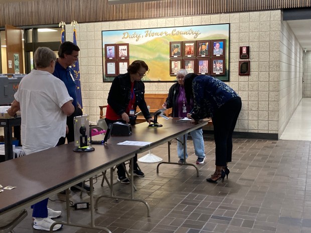 Sheila Stewart, a Lake County employee, checked in as the first voter to early vote Tuesday at the Lake County Government Center. (Alexandra Kukulka/Post-Tribune)