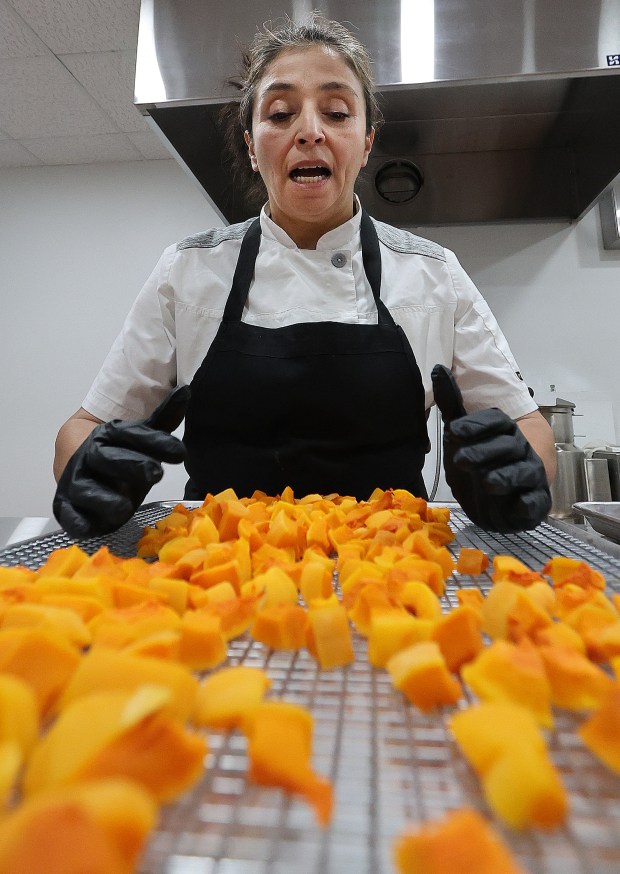 Director of the Faith Farms Fresh Frozen Project, Lucero Martinez-Donato explains the process of flash food freezing of butternut squash at the Faith Farms in Gary. Faith Fresh Frozen has started to pack up and flash freeze some of its produce to donate to the Food Bank of NWI as well as other stores on Friday, Oct. 25, 2024. (John Smierciak/for the Post Tribune)