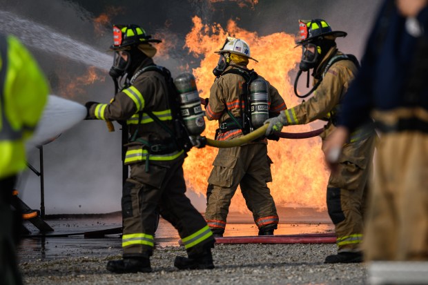 Morgan, Liberty, and Washington Township firefighters cooperate to douse a simulated plane fire during an emergency preparedeness drill at the MAAC Foundation campus on Saturday, Oct. 12, 2024. (Kyle Telechan/for the Post-Tribune)