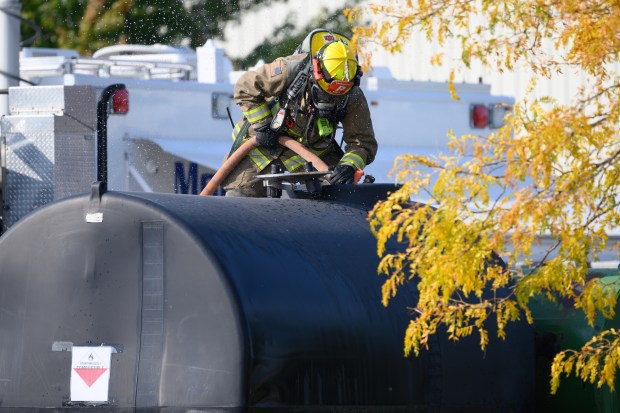 A Union Township firefighter sprays water into a simulated tank of flammable chemicals during an emergency preparedeness drill at the MAAC Foundation campus on Saturday, Oct. 12, 2024. (Kyle Telechan/for the Post-Tribune)