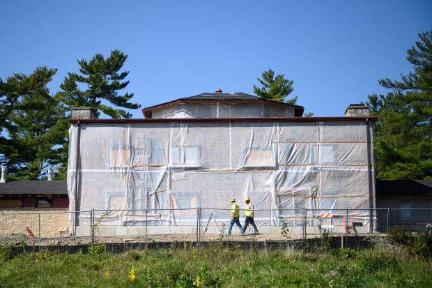 Construction workers walk the perimeter of the Good Fellow Lodge at Indiana Dunes National Park on Wednesday, Oct. 9, 2024. (Kyle Telechan/for the Post-Tribune)