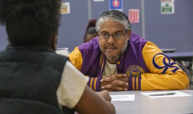 Mentor Jason Williams listens while talking with eight grader Jazmine Martin, 13, during the Youth Town Hall sponsored by the National Junior Honor Society and held at Clifford Pierce Middle School in Merrillville, Indiana Saturday Oct. 19, 2024.The event offered a unique opportunity for Pierce Students to engage with community leaders, parents and each other on issues affecting their future. (Andy Lavalley/for the Post-Tribune)