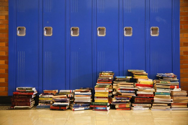 Books are stacked by lockers in a hallway at Wells Community Academy High School in Chicago on Sept. 2, 2016, before the start of school on Sept. 6.