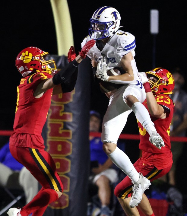 Batavia's Kyle Porter (3) and Josh Kahley (23) try to break up a pass against Wheaton North during a DuKane Conference game in Batavia on Friday, Sept. 22, 2023.