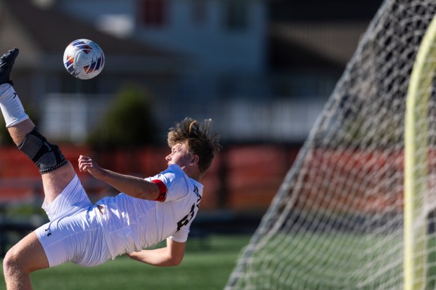 Andrew's Erick Mietus (22) on a bicycle kick to stop a ball for going out of play near the Shepard goal during the Class 3A Andrew Regional final in Tinley Park on Saturday, Oct. 26, 2024. (Vincent D. Johnson / for the Daily Southtown)