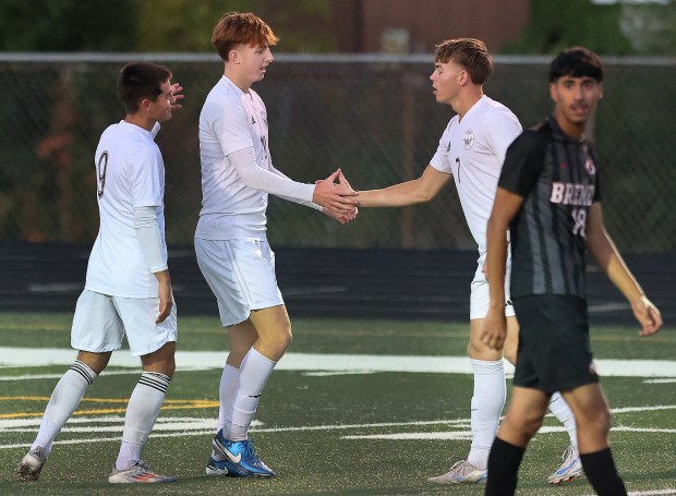 Argo's Hubert Grele (7) gets congratulated by Krystof Cicha (10) and Piotr Chmiel (9) after Grele scored against Bremen during a soccer match in Midlothian, Il., on Wednesday, Oct. 9, 2024. (John Smierciak / for the Daily Southtown)