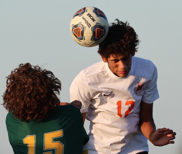 Beecher's Wences Baumgartner (12) ties a header at the Grant Park goal over the head Ryder Greenhholt (15) during a soccer match on Wednesday, Oct. 2, 2024. (John Smierciak for the Daily Southtown)