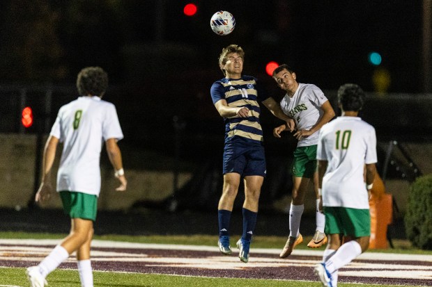 Lemont's Mitchell Sowa (11) and Providence's Luca Bullion (2) go up for a header during the Class 2A Brother Rice Sectional semifinals in Chicago on Tuesday, Oct. 29, 2024. (Vincent D. Johnson / for the Daily Southtown)