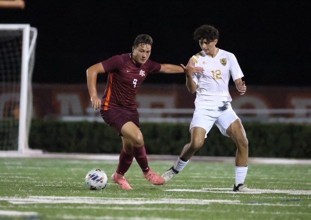 Brother Rice's Anthony Piech (9) and Oak Forest's Ulysses Morales (12) battle for control of the ball during the Class 2A Brother Rice Sectional semifinal at Brother Rice High School in Chicago on Wednesday, Oct. 30, 2024. (Talia Sprague / Daily Southtown)