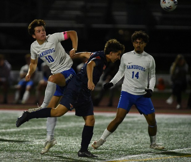 Sandburg's Joseph Gentile (10) and Stagg's Trent Banik (6) converge on the ball during the Class 3A Lincoln-Way Central Regional semifinals Tuesday, Oct. 22, 2024 in New Lenox, IL. (Steve Johnston/for the Daily Southtown)