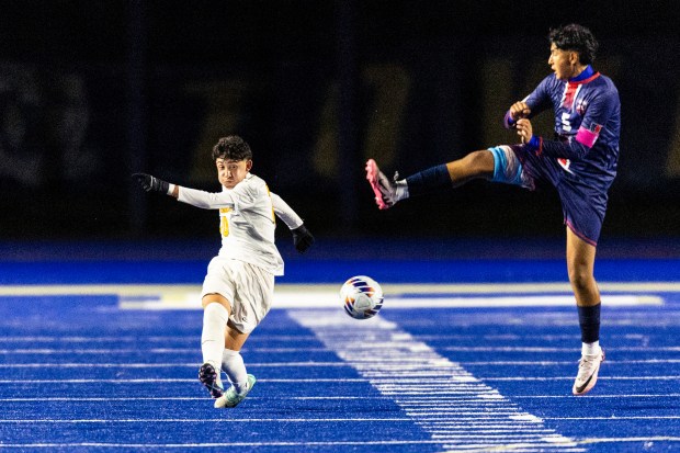 St. Laurence's Jesus Salazar (10) passes upfield as Bloom Township's Mark Bernal (5) tries to block during a nonconference game in Chicago Heights on Tuesday, Oct. 15, 2024. (Vincent D. Johnson / for the Daily Southtown)