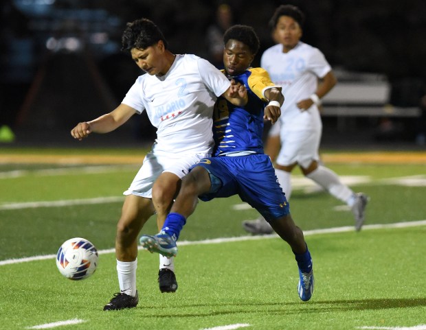 Solorio Academy's Jose Teudocio (2) and De La Salle's Joshua Lawson (19) battle for the ball during the Class 2A St. Laurence Sectional semifinals Wednesday, Oct. 30, 2024 in Burbank, IL. (Steve Johnston/Daily Southtown)