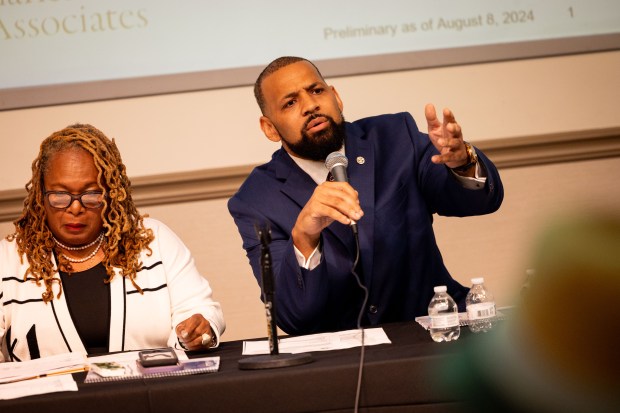 Dolton Trustee Jason House addresses the room before Former Chicago Mayor Lori Lightfoot speaks about preliminary findings regarding Dolton Mayor Tiffany Henyard's administration at Lester L. Long Fieldhouse in Dolton on Aug. 8, 2024. Lightfoot was hired by Dolton trustees as a special investigator to probe the spending habits of Dolton Mayor Tiffany Henyard. The investigation found that the village's General Fund has a negative balance of $3.65 million as of May 31, 2024, while under Henyard's administration, among a misuse of credit cards, unfunded expenditures, and other findings. (Tess Crowley/Chicago Tribune)