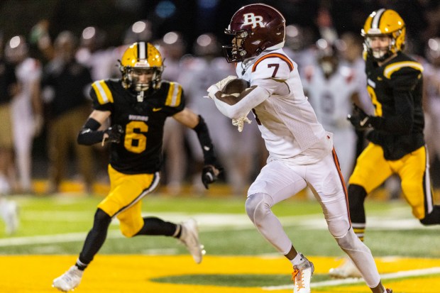 St. Laurence's Mickey Lotus (6) chases down Brother Rice's KJ Morris (7) on a kickoff during a CCL/ESCC crossover game in Burbank on Friday, Oct. 18, 2024. (Vincent D. Johnson / for the Daily Southtown)