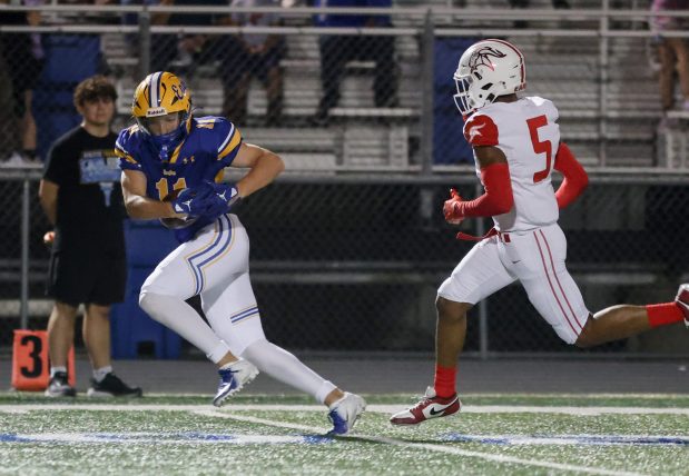 Sandburg's Charlie Snoreck (11) gets yards after the catch against Homewood-Flossmoor during a non conference game in Orland Park on Friday, Sept. 13, 2024. (Troy Stolt / Daily Southtown)