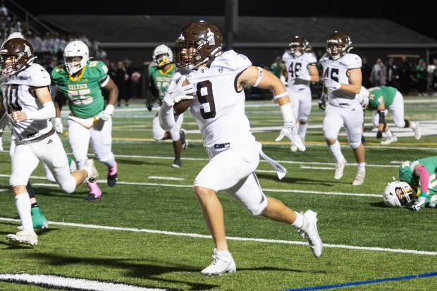 Joliet Catholic's Zac Beitler (9) returns a punt for a touchdown against Providence during an ESCC game in New Lennox on Friday, Oct. 25, 2024. (Troy Stolt / for the Daily Southtown)