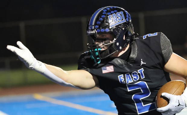 Lincoln-Way East's Trey Zvonar (2) gestures to the crowd after scoring against Lockport during a football game in Frankfort, Il., on Friday, Oct. 11, 2024. (John Smierciak / Daily Southtown)