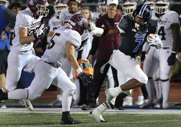 Lincoln-Way East's Zion Gist stiff arms Lockport's Payton Roberson (5) as he heads for the end zone to score during a football game in Frankfort, Il., on Friday, Oct. 11, 2024. (John Smierciak / Daily Southtown)