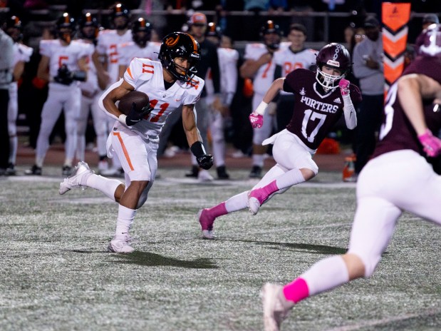 Lincoln-Way West's Austin Rowswell (11) runs the ball during a game at Lockport Township High School in Lockport, IL, on Friday, Oct. 16, 2024. (Nate Swanson / for the Daily Southtown)