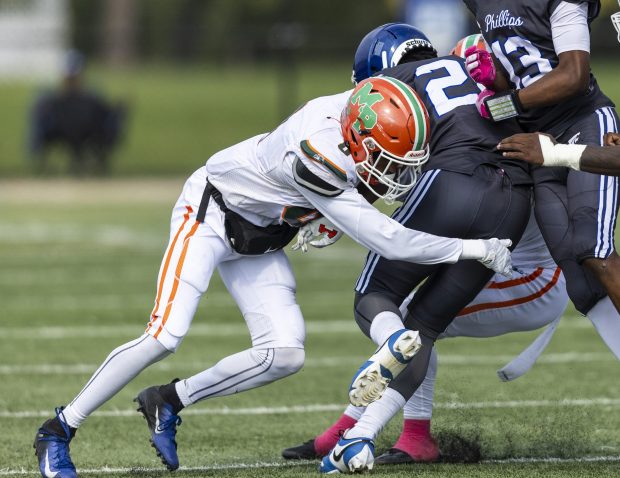 Morgan Park's Jahmare Washington, left, puts a hit on Phillips' Wellington Gibson-Hall during a Chicago Public Red game at Gately Stadium in Chicago on Saturday, Oct. 12, 2024. (Vincent D. Johnson / for the Daily Southtown)