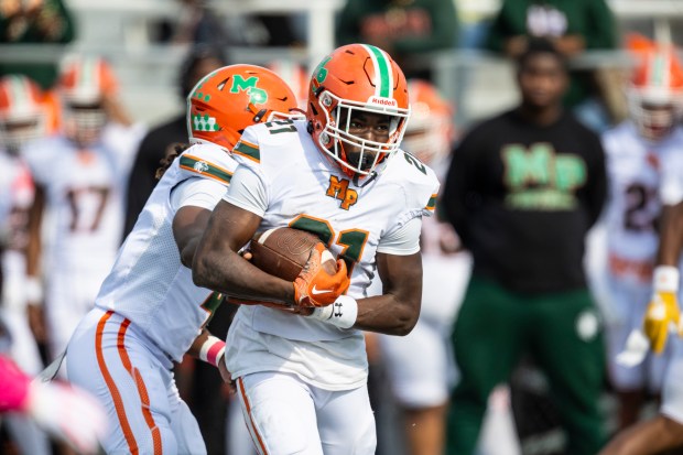 Morgan Park's Reggie Gray Jr (21) rushes against Phillips during a Chicago Public Red game at Gately Stadium in Chicago on Saturday, Oct. 12, 2024. (Vincent D. Johnson / for the Daily Southtown)