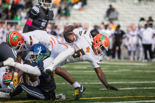 Morgan Park's Terrance Gurley (5) braces to land in the end zone for the Mustangs' first score against Phillips during a Chicago Public Red game at Gately Stadium in Chicago on Saturday, Oct. 12, 2024. (Vincent D. Johnson / for the Daily Southtown)