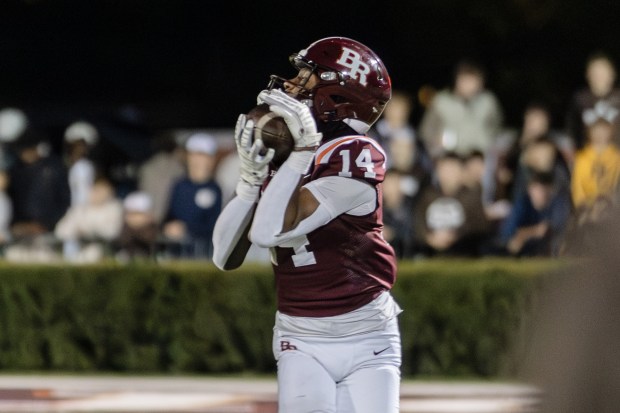 Brother Rice's Jimmie Maxson III (14) catches a pass against Mount Carmel during a CCL/ESCC Blue conference game in Chicago on Friday, Oct. 4, 2024. (Troy Stolt / Daily Southtown)