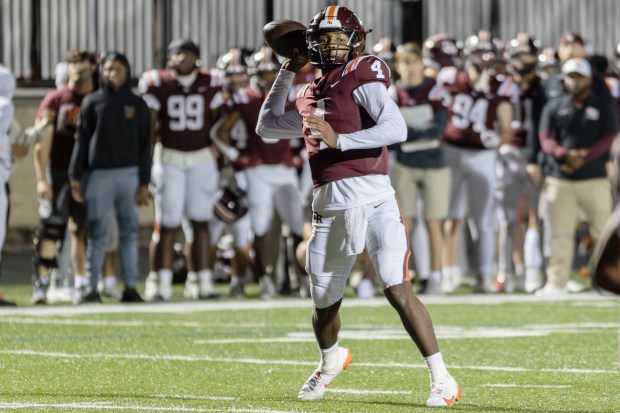 Brother Rice's CJ Gray (4) throws the ball against Mount Carmel during a CCL/ESCC Blue conference game in Chicago on Friday, Oct. 4, 2024. (Troy Stolt / Daily Southtown)