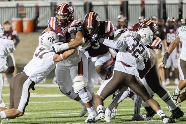 Brother Rice's Tyler Lofton (3) runs the ball against Mount Carmel during a CCL/ESCC Blue conference game in Chicago on Friday, Oct. 4, 2024. (Troy Stolt / Daily Southtown)